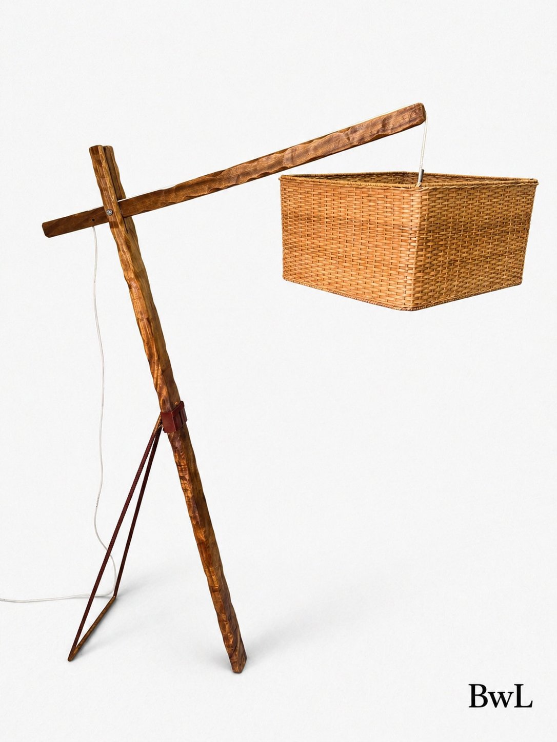 The VII — A branch-wood floor lamp with a hanging woven shade.